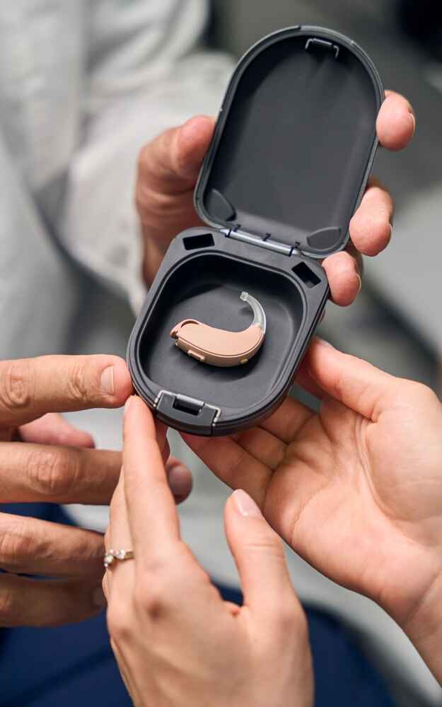 Audiologist showing patient her new hearing aids