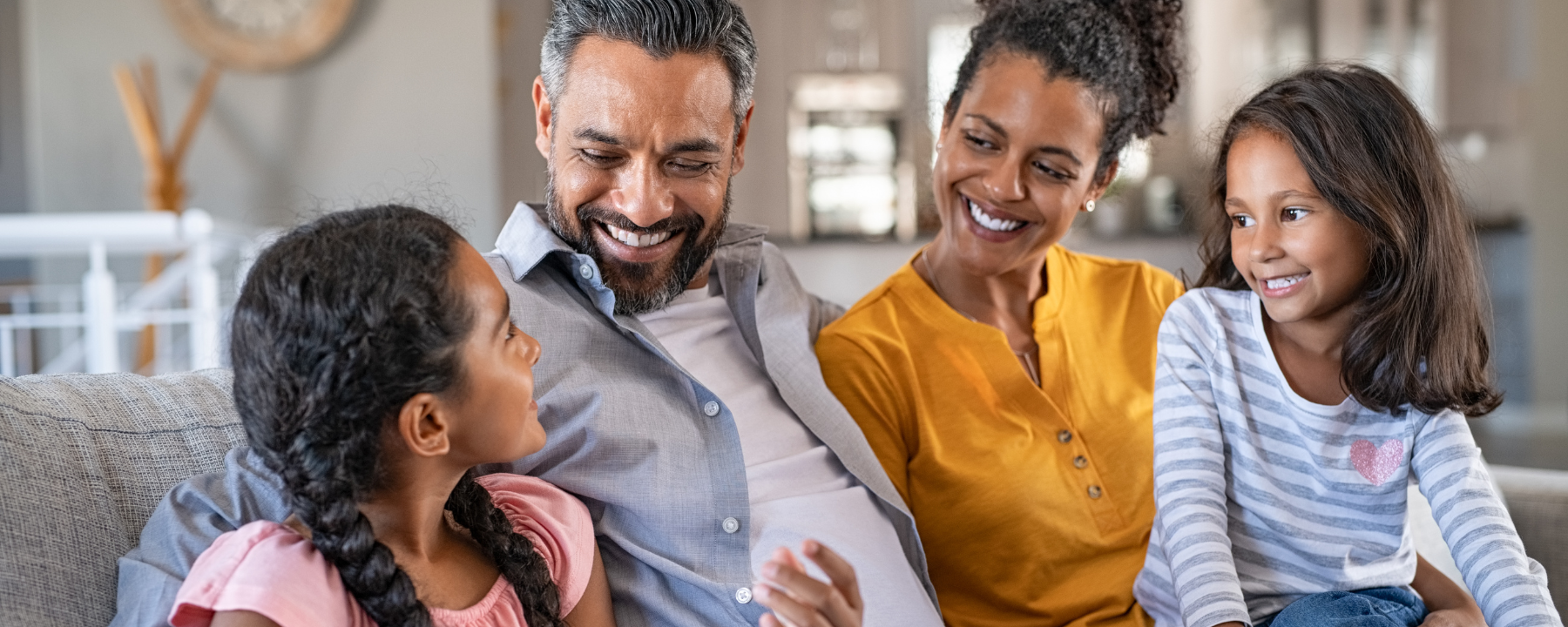 Happy family sitting together and smiling on a coach